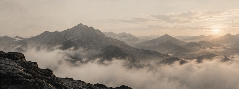 A misty mountain range at sunrise
